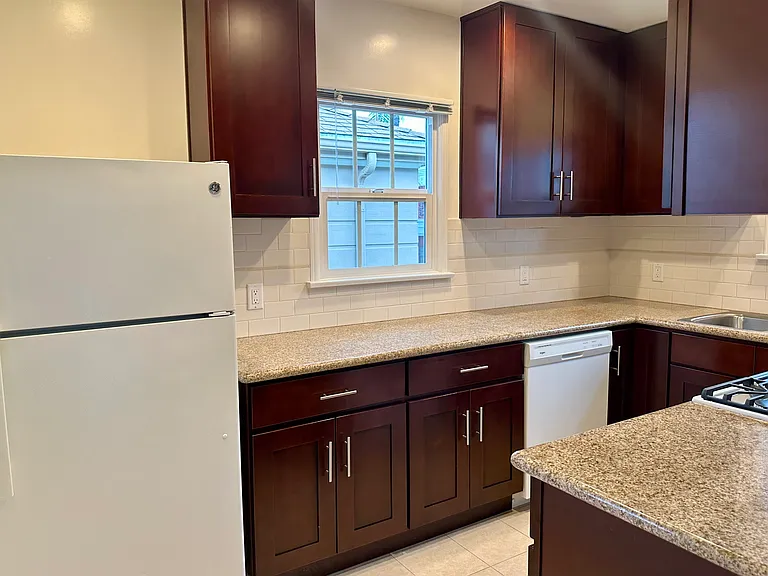 Refrigerator, dishwasher, two kitchen windows allows a lot of sunlight coming in