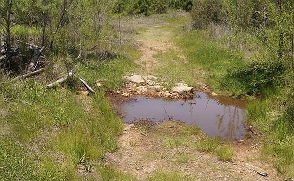 This was a culvert crossing the wet weather creek. This road will take you back to the original trai