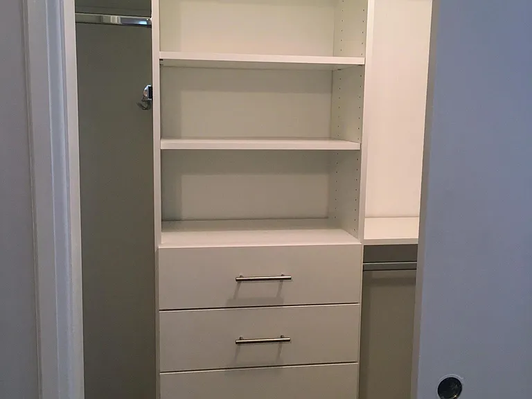 Primary bedroom walk-in closet with soft close drawers.