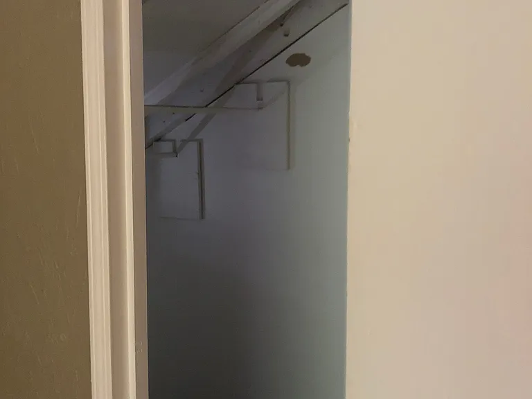 clothes hanging bar on both sides of walk-in closet
