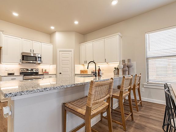 Bar seating in the Nikki, one of Betenbough s homes with open floor plan.