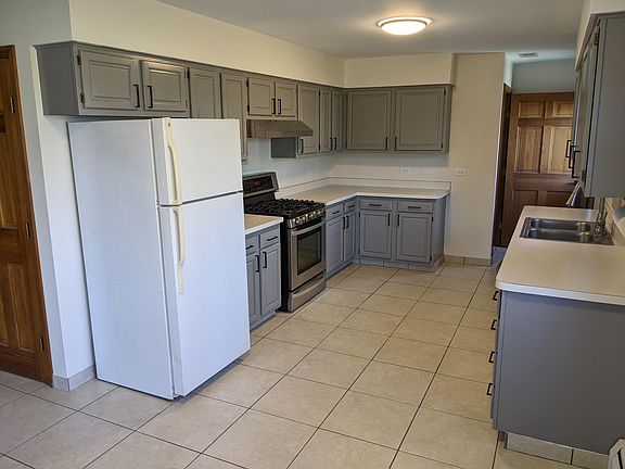 Kitchen with gas range, new hood vented to outside, and brand new microwave.