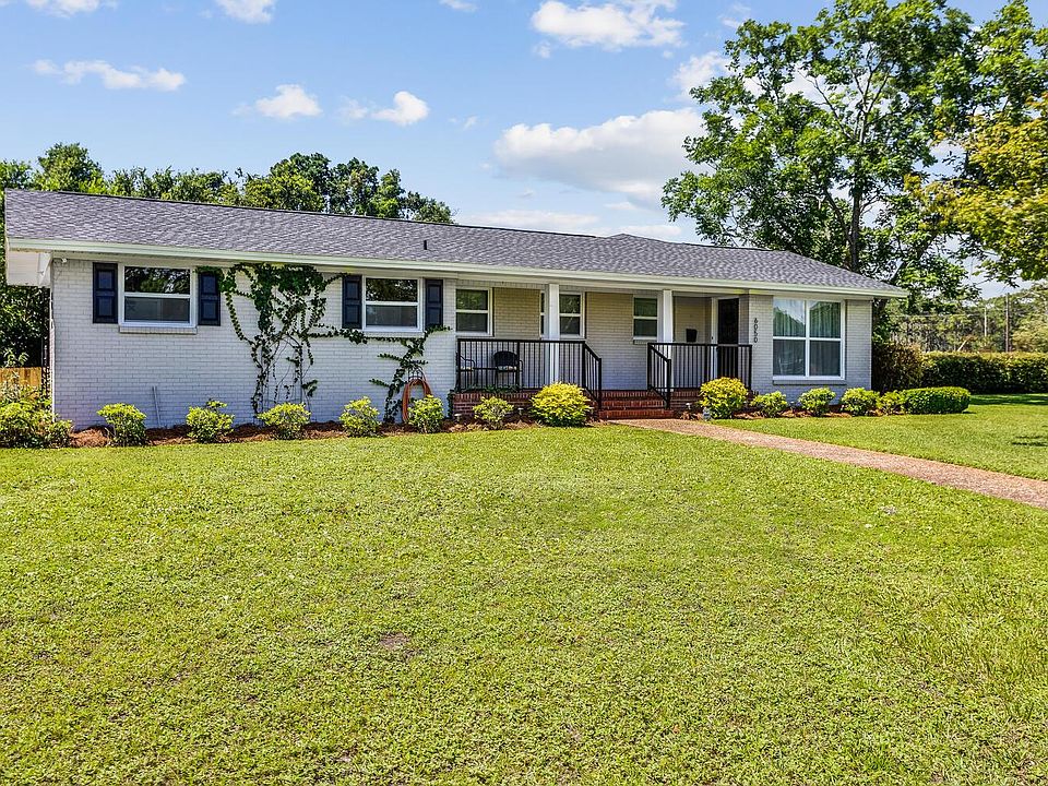 Huge front yard, freshly painted brick, black shutters, azalea bushes throughout.