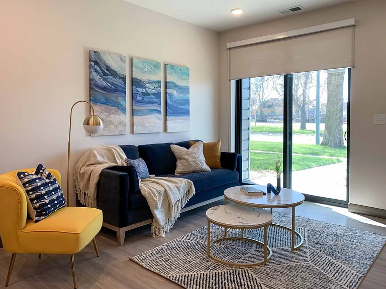 The living room of our model 1-bedroom Marble floor plan.