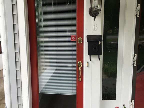 Apartment B front door that leads to upstairs unit