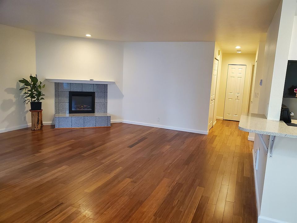 Living Room with Fireplace and connecting Hallway Closets and Bedrooms.