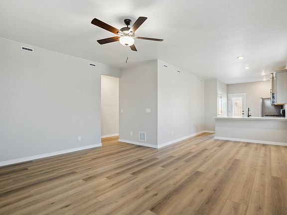 The family room is spacious with a ceiling fan.