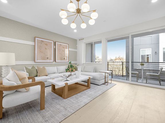 Gathering room with sliding glass door and balcony access