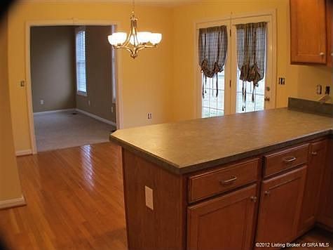 VIEW OF BREAKFAST ROOM AND LIVING ROOM FROM KITCHEN.