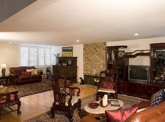 Spacious living room with stone fireplace 