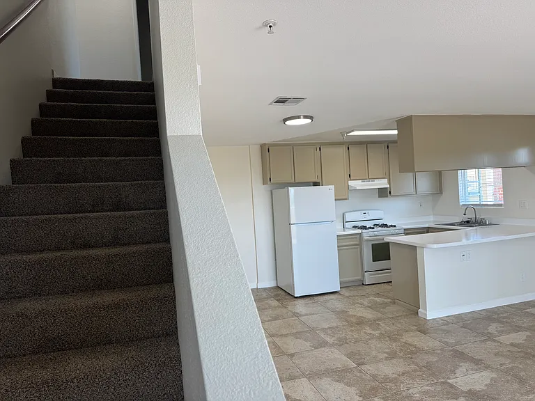 Stairs leading to the two bedrooms and two bathrooms.
