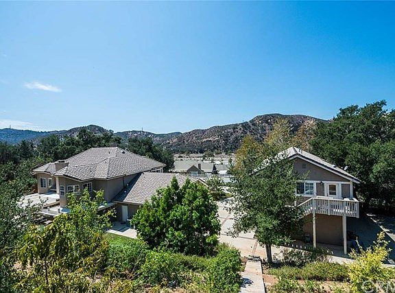 This exquisite property is comprised of a 4600 sq. ft. Main House (shown on left)  and a 1400 sq. ft. Guest House with 3 car garage and storage room below (shown on right).