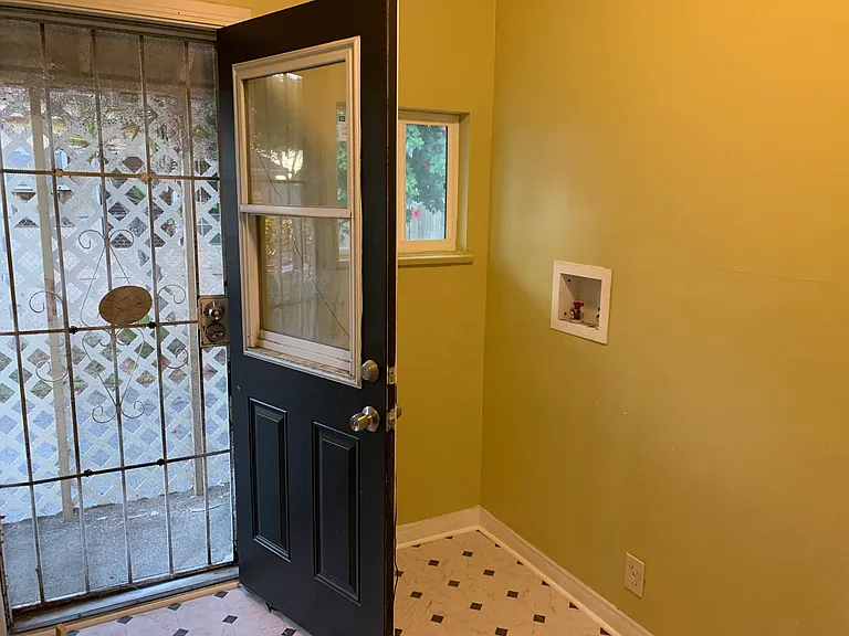 Dedicated laundry room next to kitchen with washer/dryer hookups and side entry to house makes bringing in groceries a breeze.