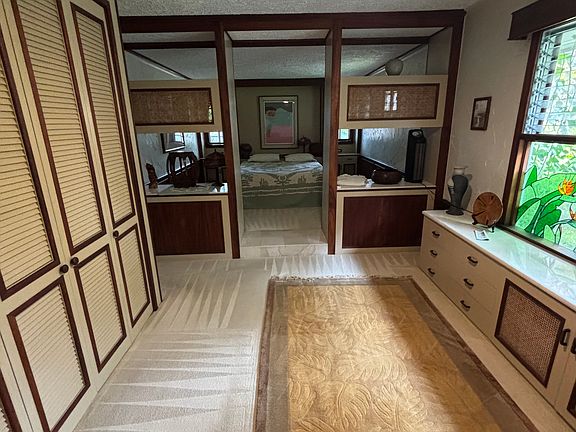 Master bedroom featuring custom stained glass, closets and built in storage