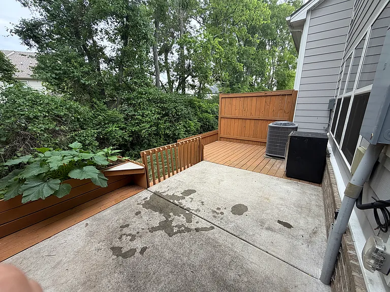nice back patio with extended wood deck and gate