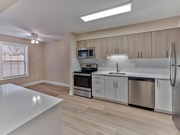 Preview the designer kitchen finishes coming soon to North Crossing Apartments _ featuring stainless steel appliances, quartz countertops, and contemporary cabinetry, as shown here at our sister community, Woods Edge.