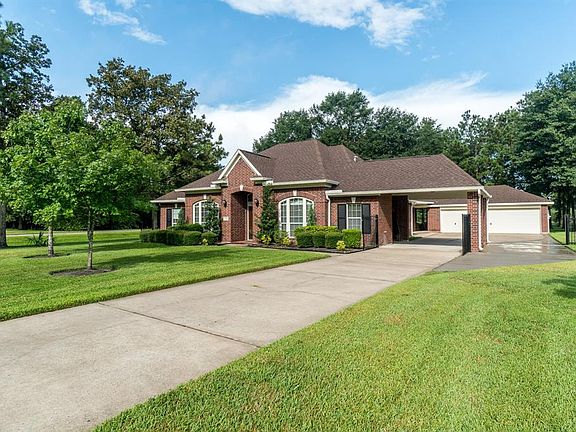 This extended driveway is truly amazing and leads into an open carport and 3 car detached garage.