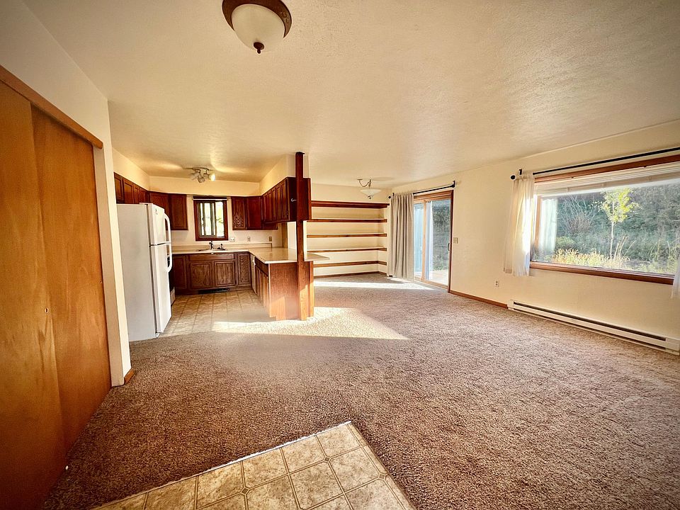 Living area, bright sunny window and glass sliding door to patio area.
