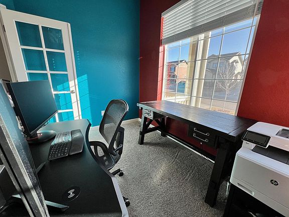 Front office, with french doors. Perfect for the work-at-home mom or dad. 
 Two windows provide ample light!