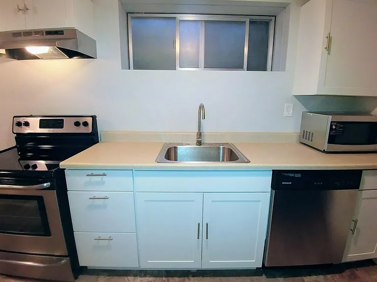 Kitchen w/ stainless steel appliances.