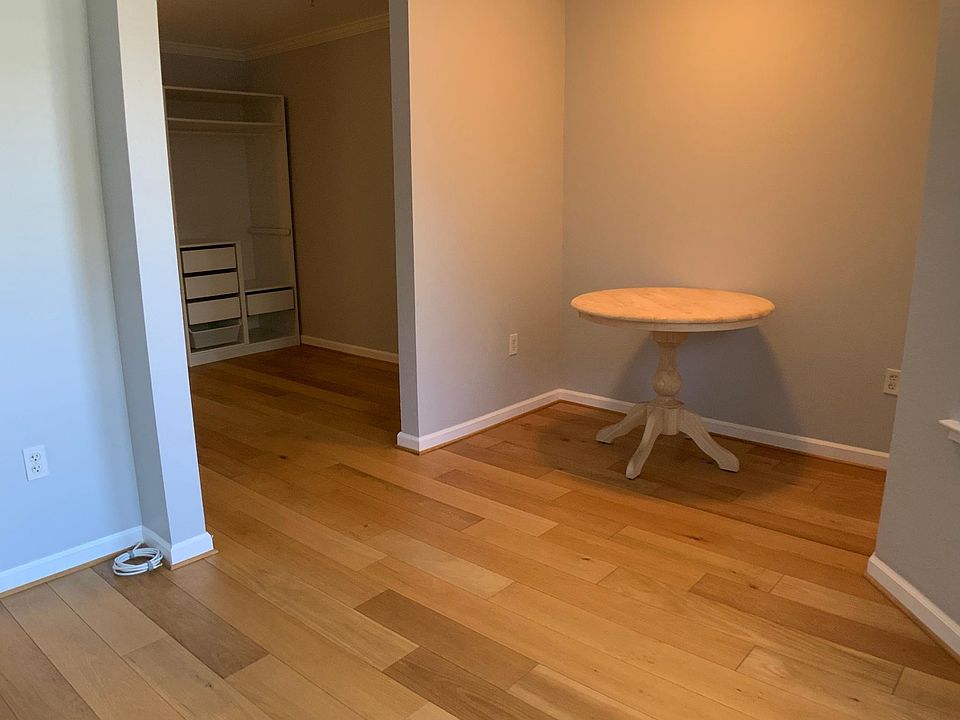 Dining Nook open to Living Room Area (Bay Windows on the right and bedroom on the left)