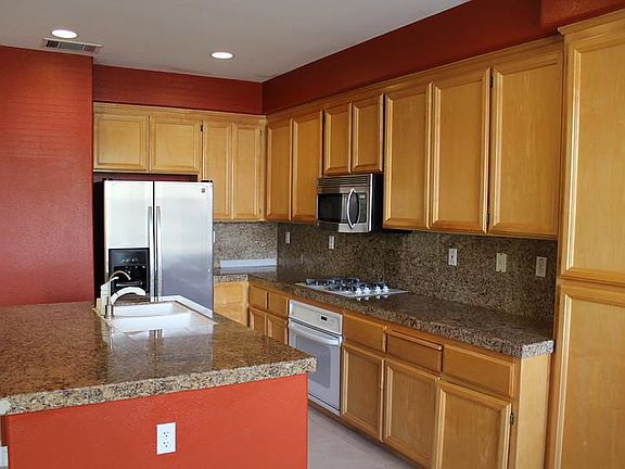 Bright kitchen with granite counters, modern appliances and tons of storage