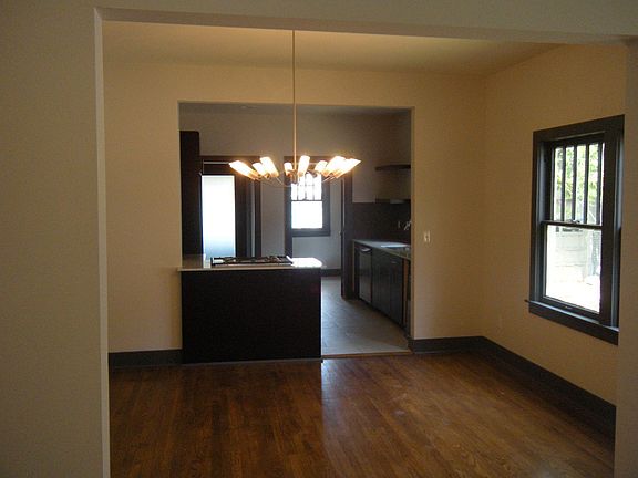 Formal dining with beautiful fixtures and hardwoods