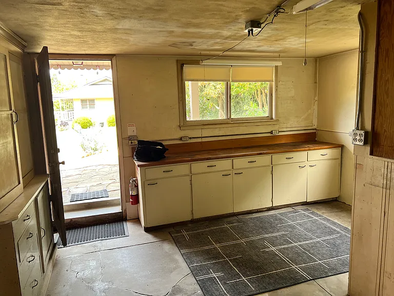 Walkout basement workshop provides amble storage with built-in workbench/storage.