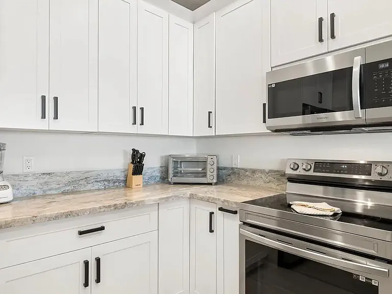 Toaster oven, blender, drip coffee machine, all cooking utensils, pots/pans/baking sheets and place settings for eight included