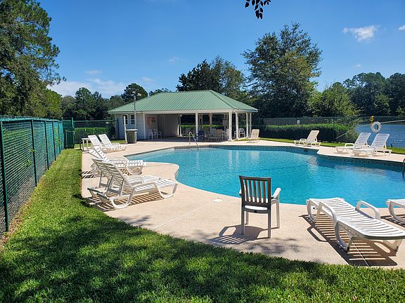 Pool Complex with electronic gate, showers, covered area with tables.