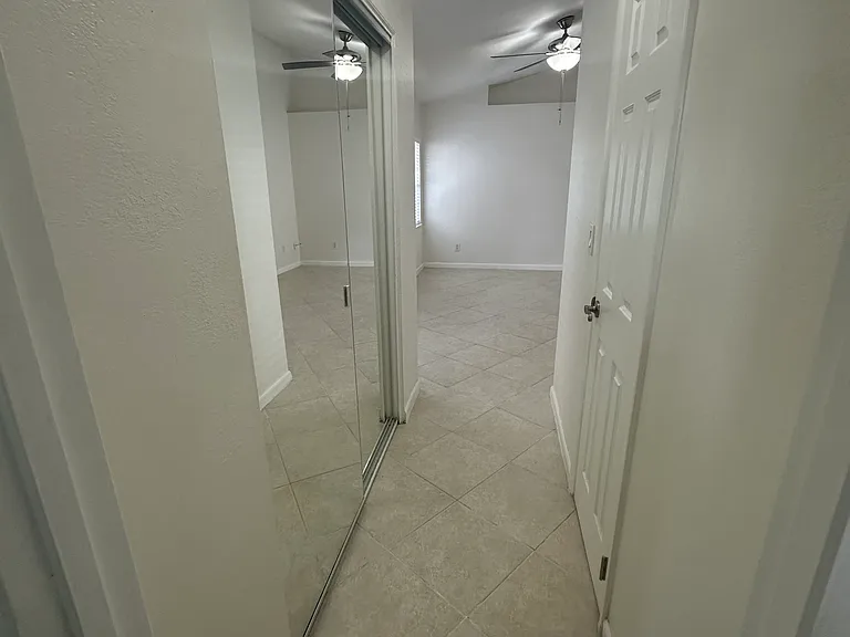Master/Main bedroom hallway to walking closet, closet and primary bathroom view from primary bathroom.