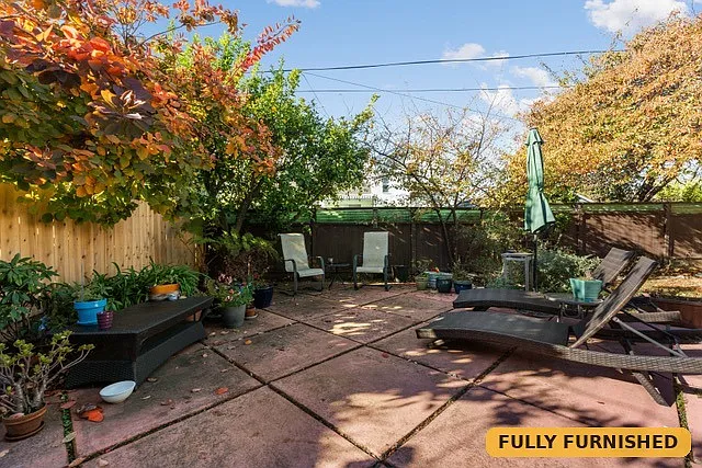 Backyard patio with sun loungers and BBQ is just outside the bonus space downstairs.