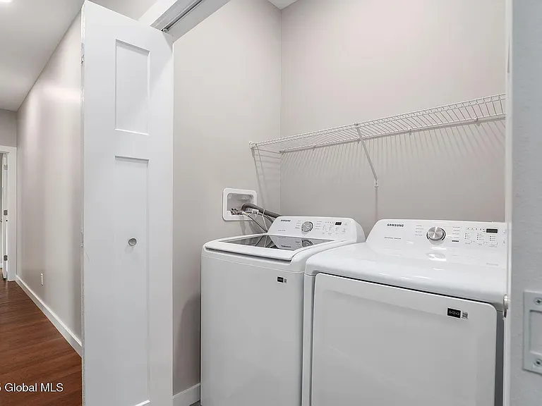 Laundry room is off to the side of the hallway.