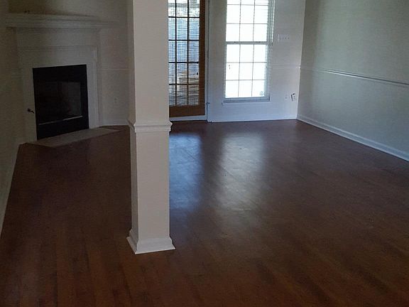 Living Room with Gas Log Fireplace and Door to Florida Room