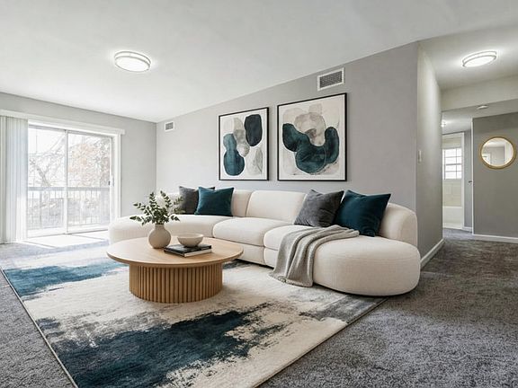 Elevate your living space at Parkside Apartments with this stylish, open-concept living room. Featuring modern decor and natural light, it's designed for comfort and relaxation. Imagine your ideal lifestyle here schedule a visit today!