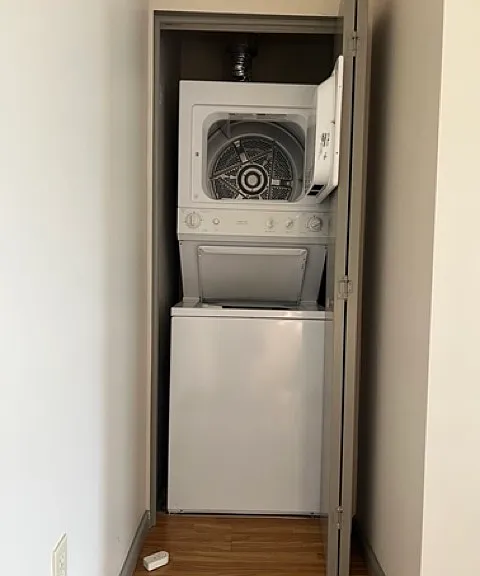 Stacked washer/dryer in unit