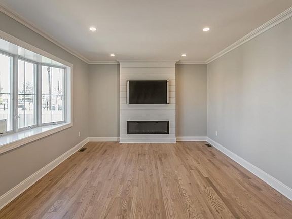 Living Room With Built-In Fireplace & 54" TV