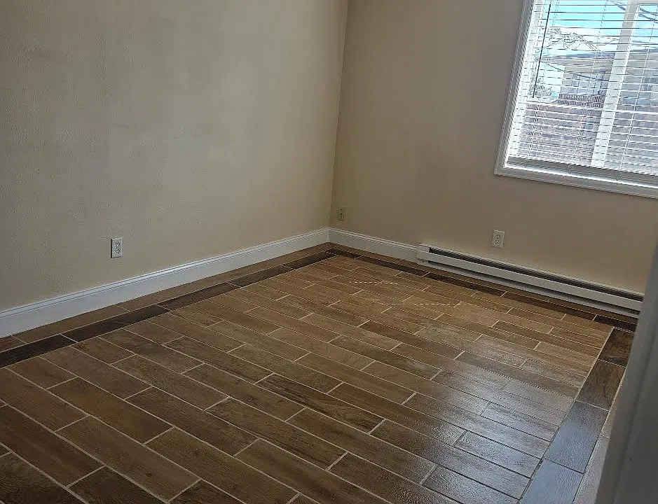 East bedroom with brand new tile flooring. Easy-peezy cleaning!