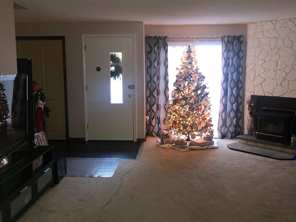 Main entry, living room, fire place, and stairs to upstairs bedrooms.