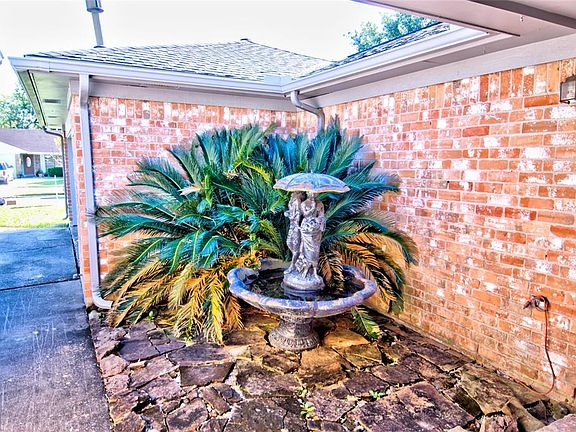 This secluded fountain area by the front door could also be a garden.