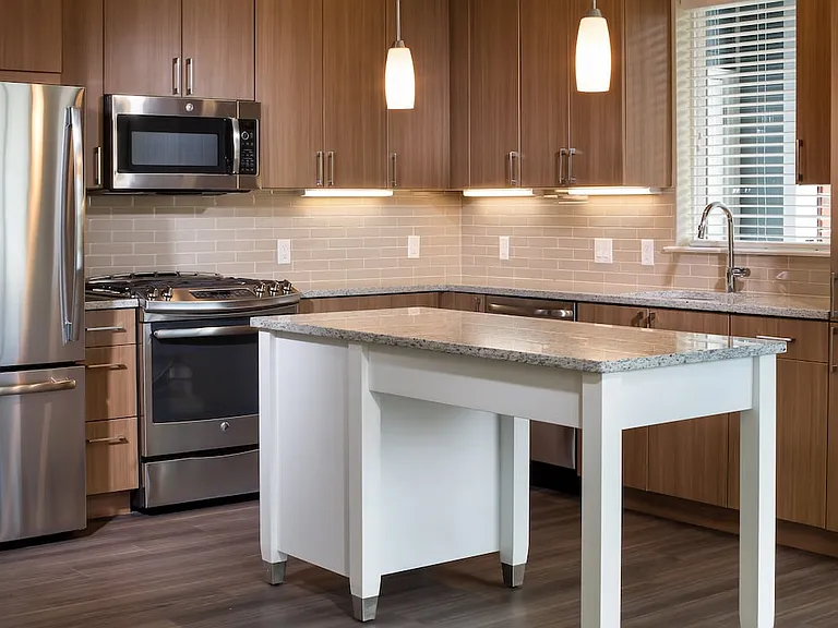Traditional Collection Kitchen with oak cabinetry, beige tile backsplash, grey granite countertops, stainless steel appliances, and hard surface flooring