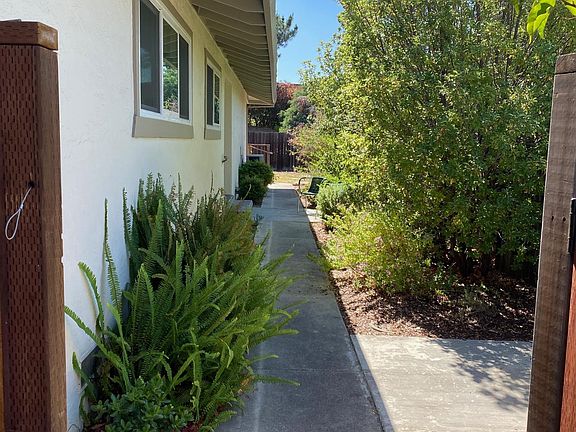 Private fenced entrance with landscaping