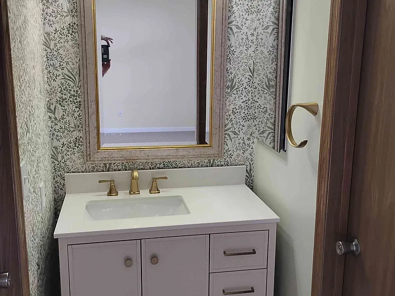 Master bedroom has its own vanity cabinet and sink.