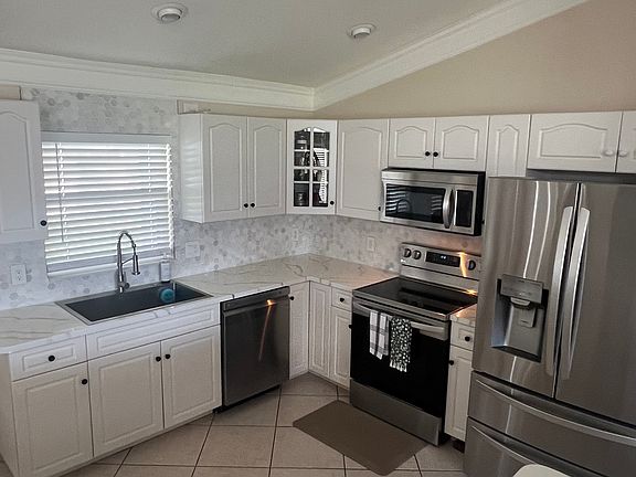 Newly backsplashes kitchen; stainless steel appliances.