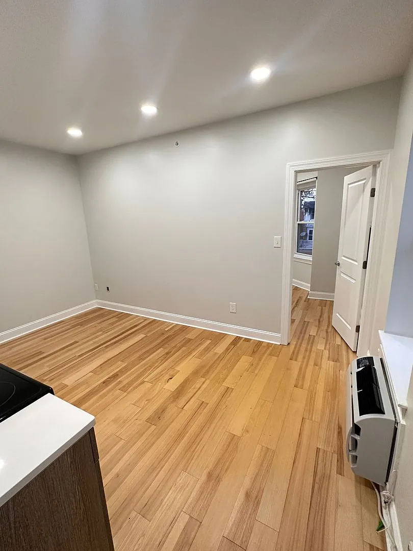 1-bedroom with a bay window and refinished hardwood — Photo 2