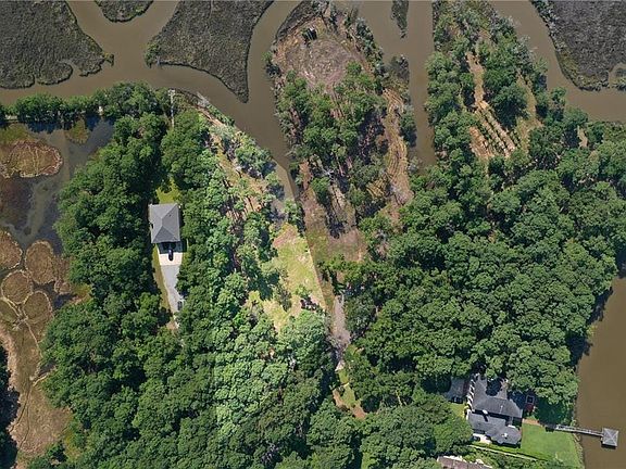 Expansive property featuring a single-family residence, mature tree coverage, and a private driveway leading to the home