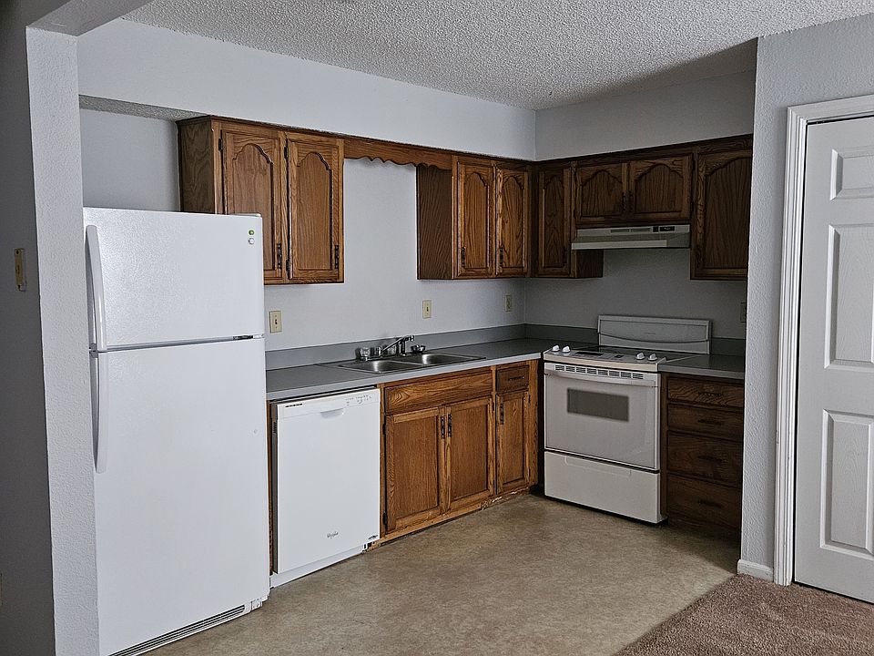 Kitchen showing refrigerator, dishwasher, sink, cabinets & stove