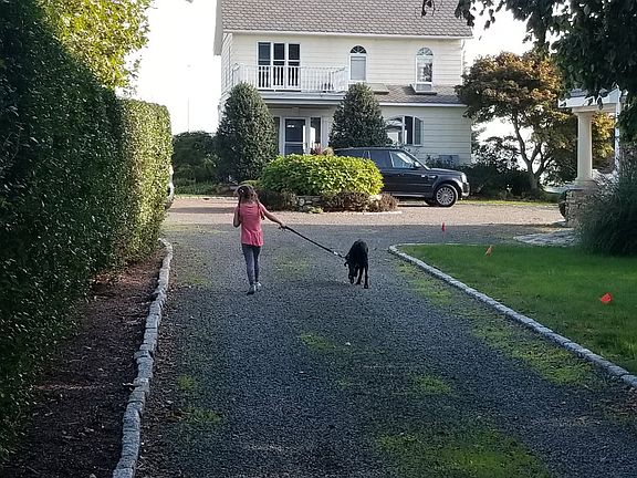 The gravel driveway set back from the street....