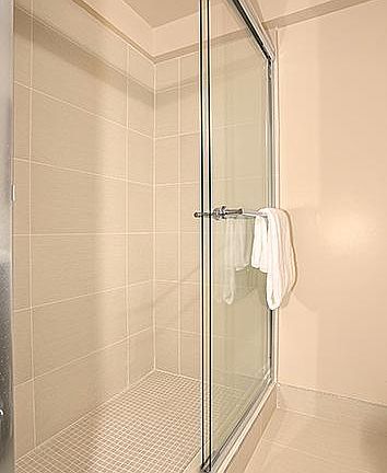 Glass shower doors and newly tiled shower
