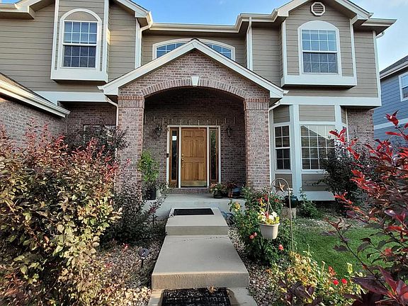 Gorgeous roses flank the walkway as you approach the front door